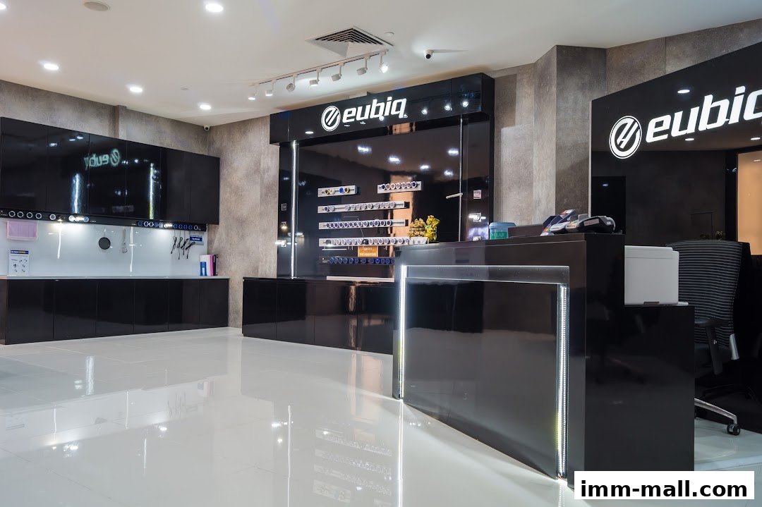 Interior of a modern retail store with sleek black counters and displays showcasing products.