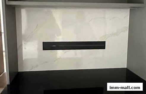 A modern fireplace with a marble-effect surround and a black insert.