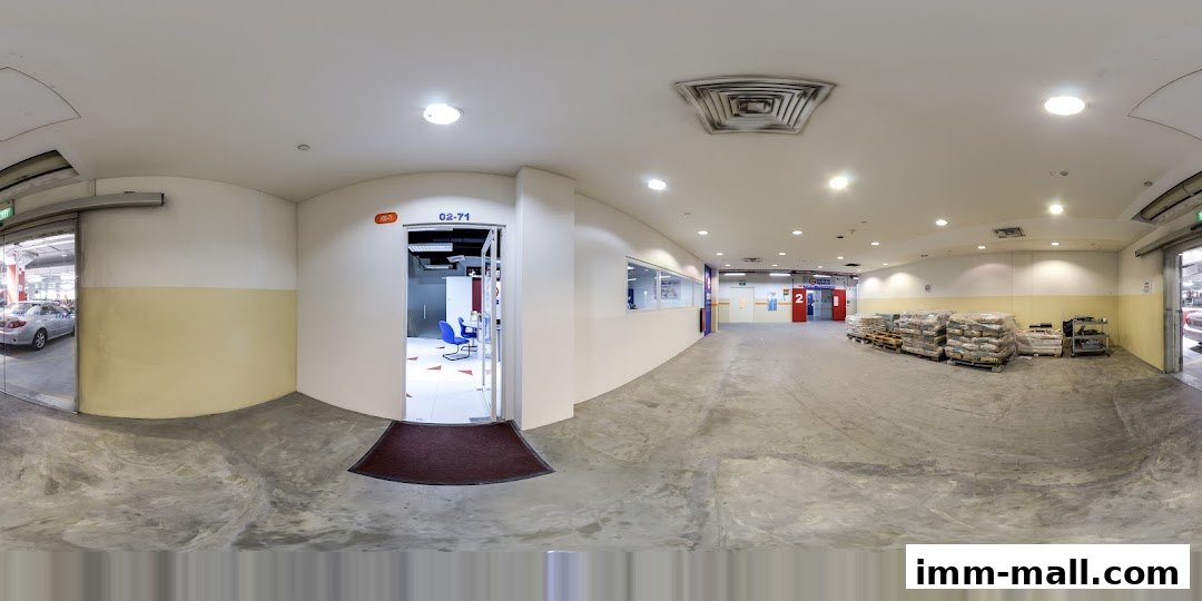 Interior view of a storage facility with stacked goods and office spaces.