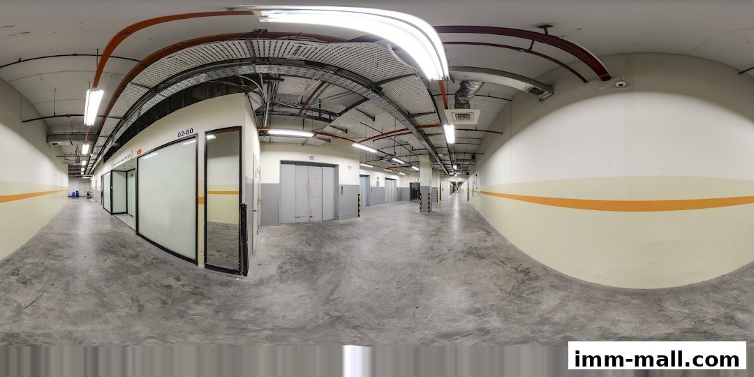 A wide-angle view of a clean, modern corridor with multiple doors and elevators.