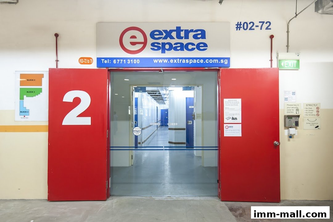 The entrance to Extra Space storage facility with red doors and a sign.