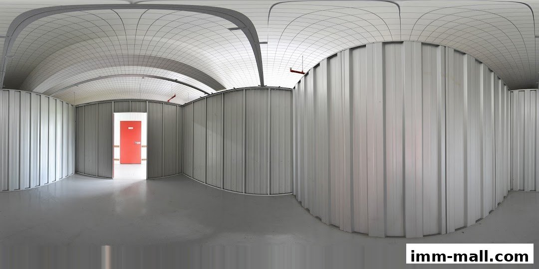 Interior view of a clean, modern storage unit with a bright red door.
