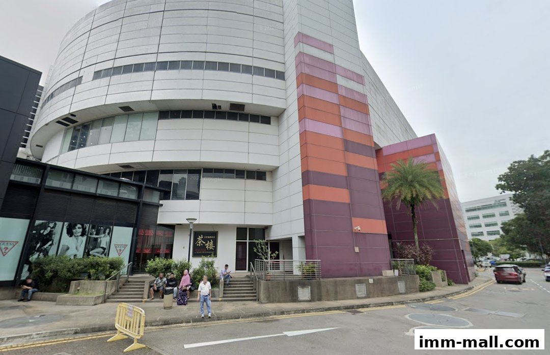 Exterior view of Extra Space IMM building with a Guess store and a restaurant entrance.