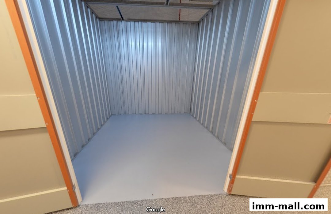 An empty, clean storage unit with metal walls and a light grey floor.