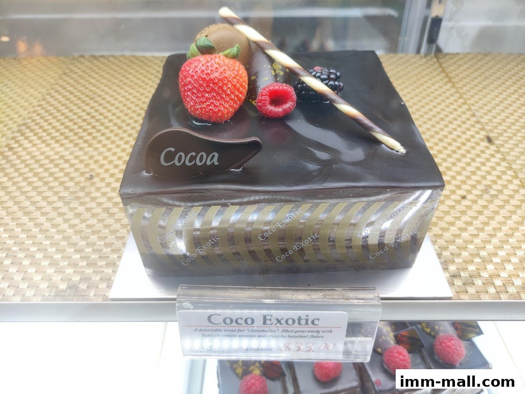 A decadent chocolate cake topped with fresh berries and a chocolate swirl.
