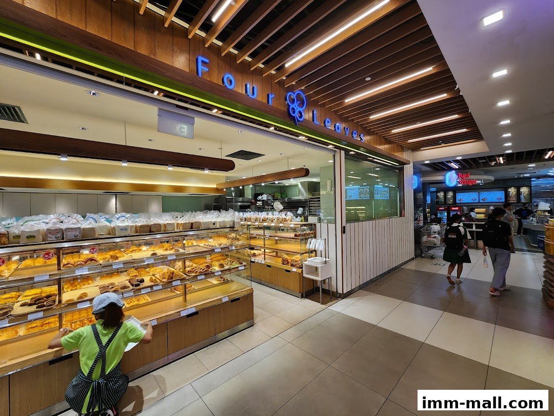A bakery shop called Four Leaves with a wide display of fresh bread and pastries.