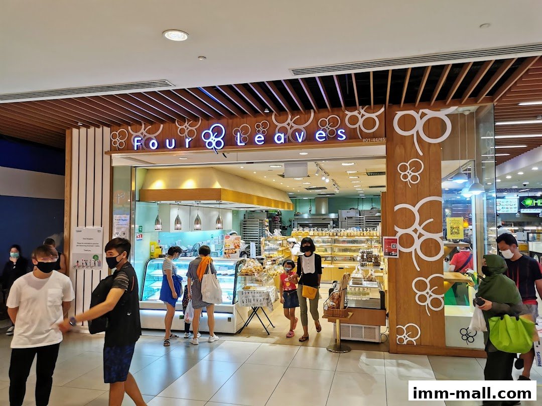 People are seen entering a bakery called Four Leaves, which displays various baked goods.