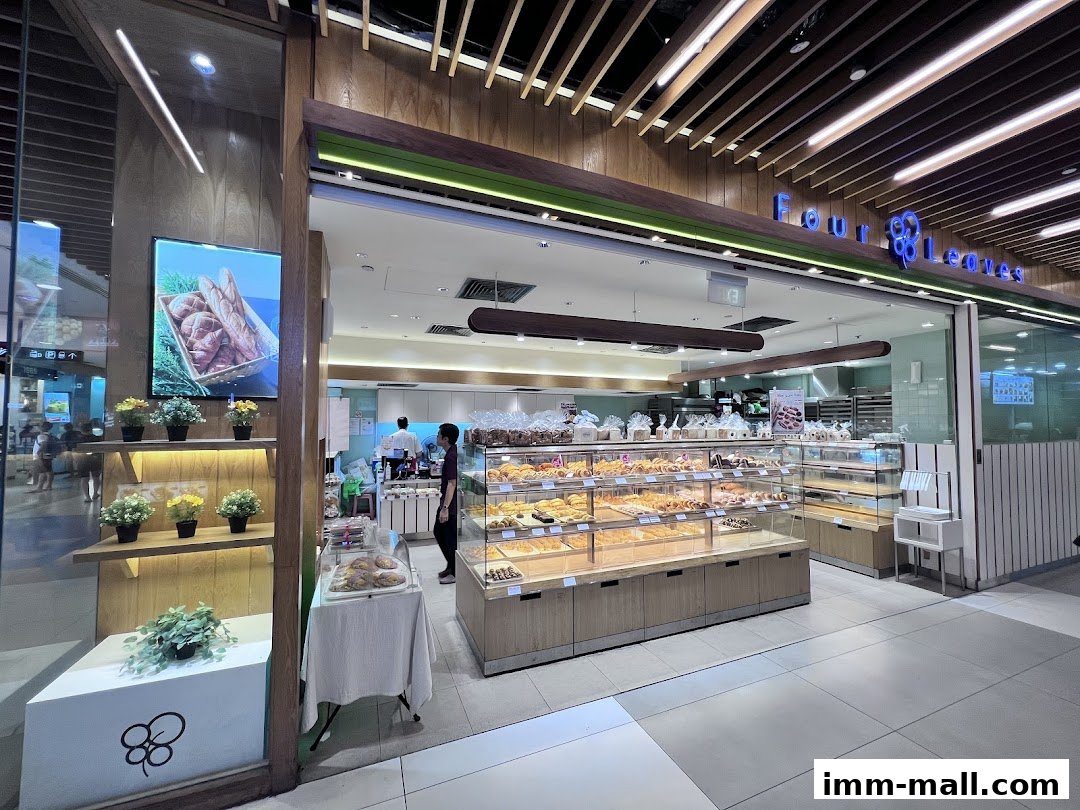 A bakery shop called Four Leaves with a display of fresh pastries and bread.