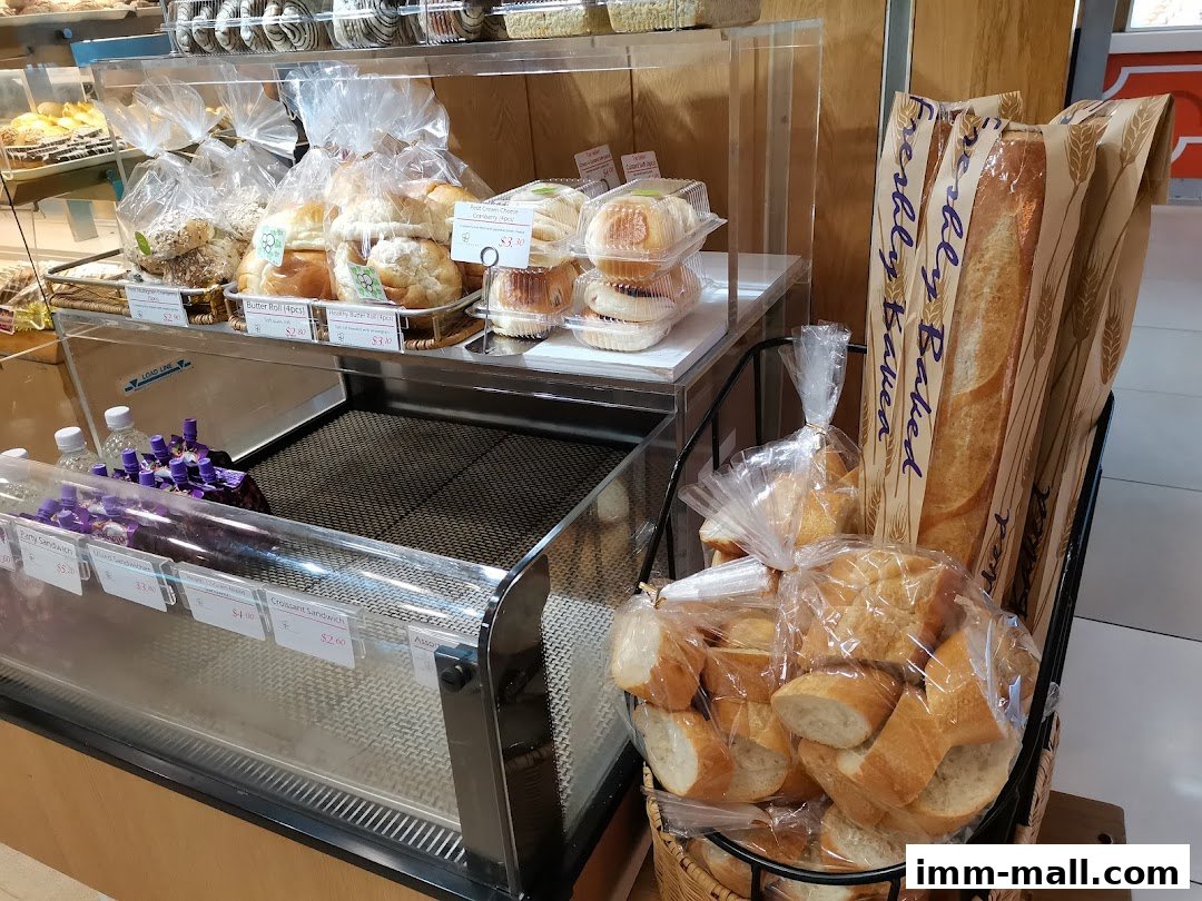 A display of freshly baked bread and pastries at a bakery.
