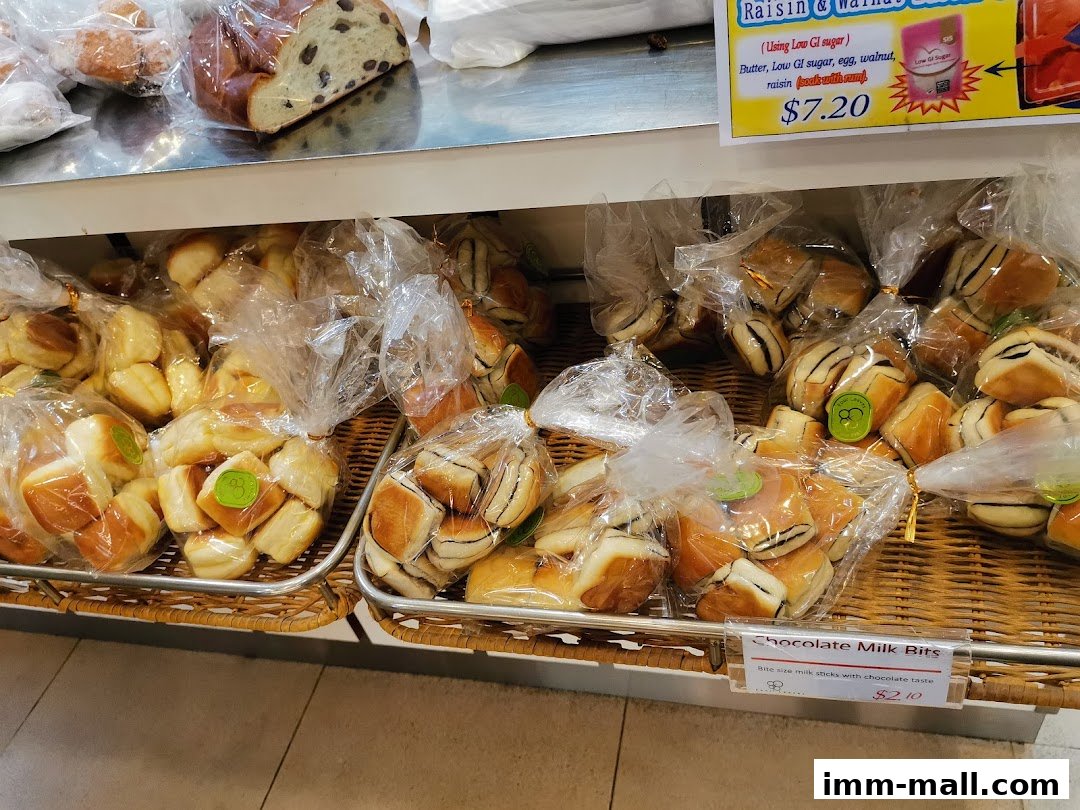 A display of freshly baked bread and pastries, many individually packaged.