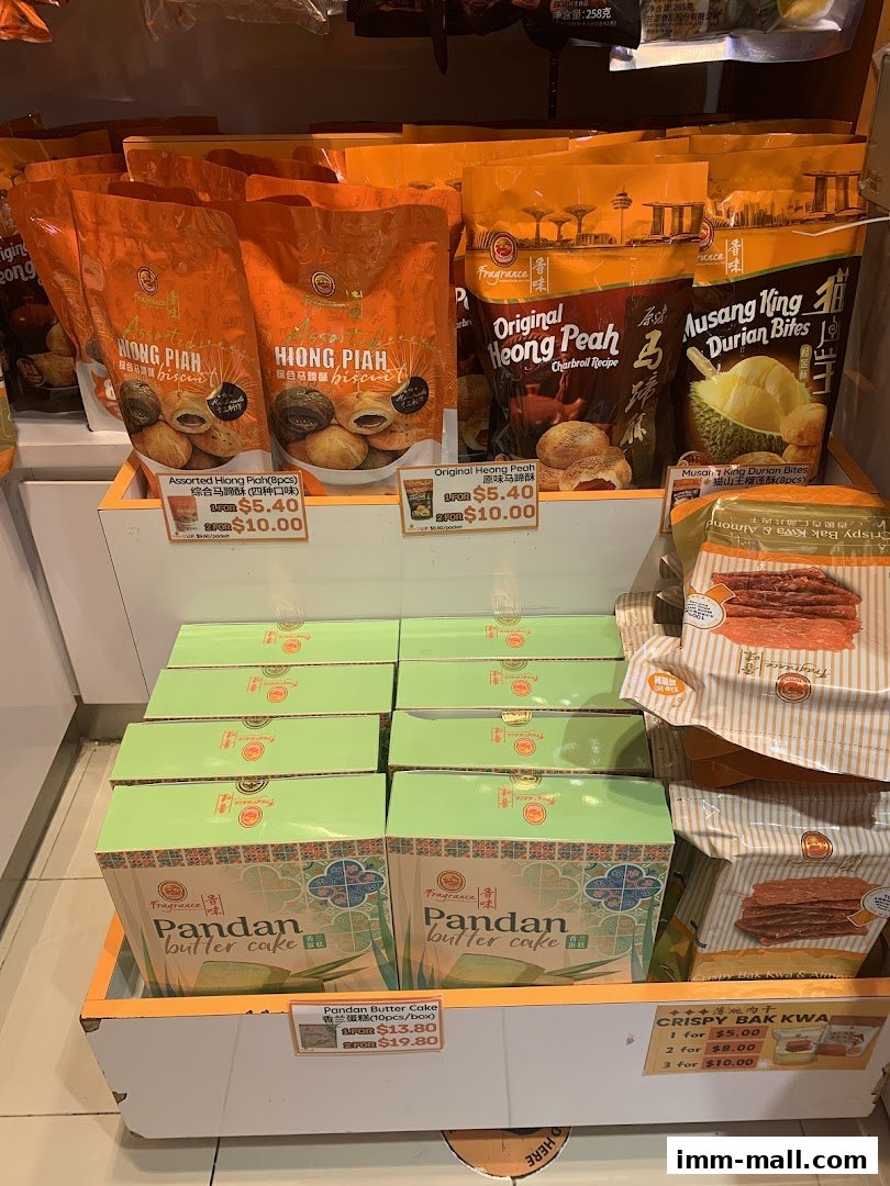 A display of various snacks including biscuits, cakes, and bak kwa from Fragrance.