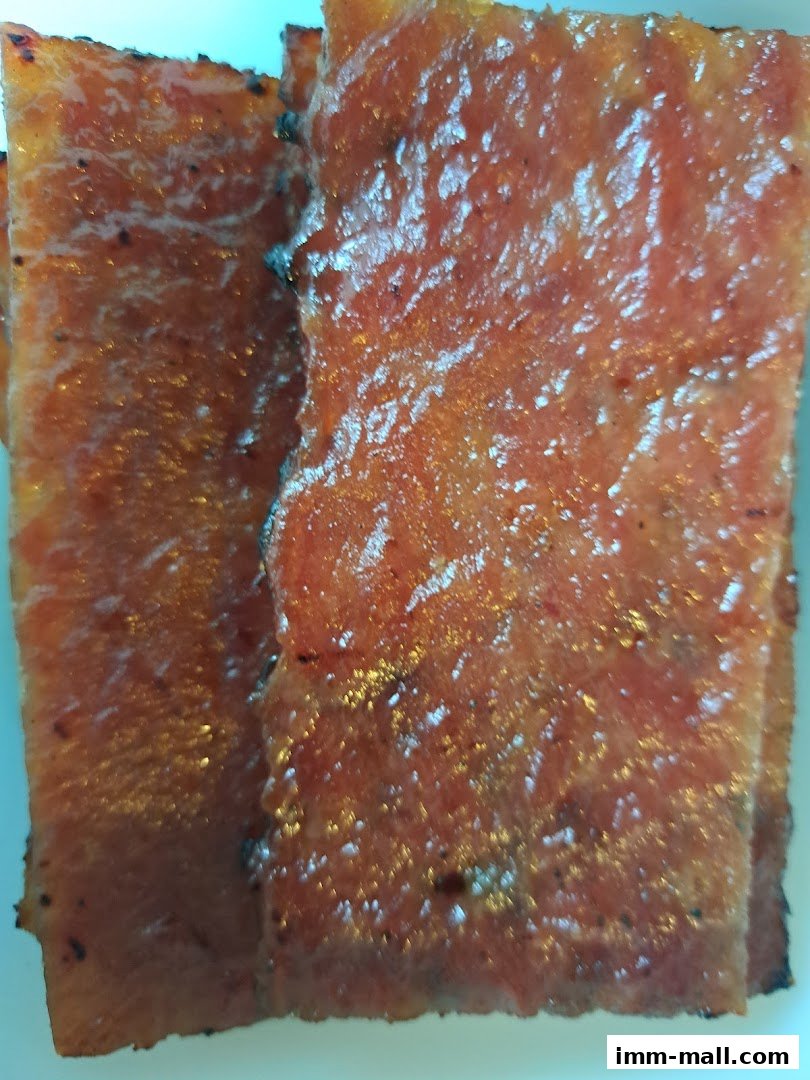 Close-up of glistening, sweet and savory bak kwa slices.