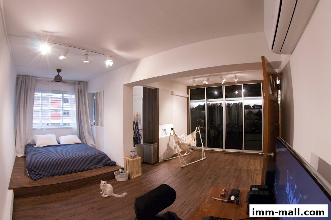 A modern bedroom with a raised bed, walk-in closet, hammock, and a cat.