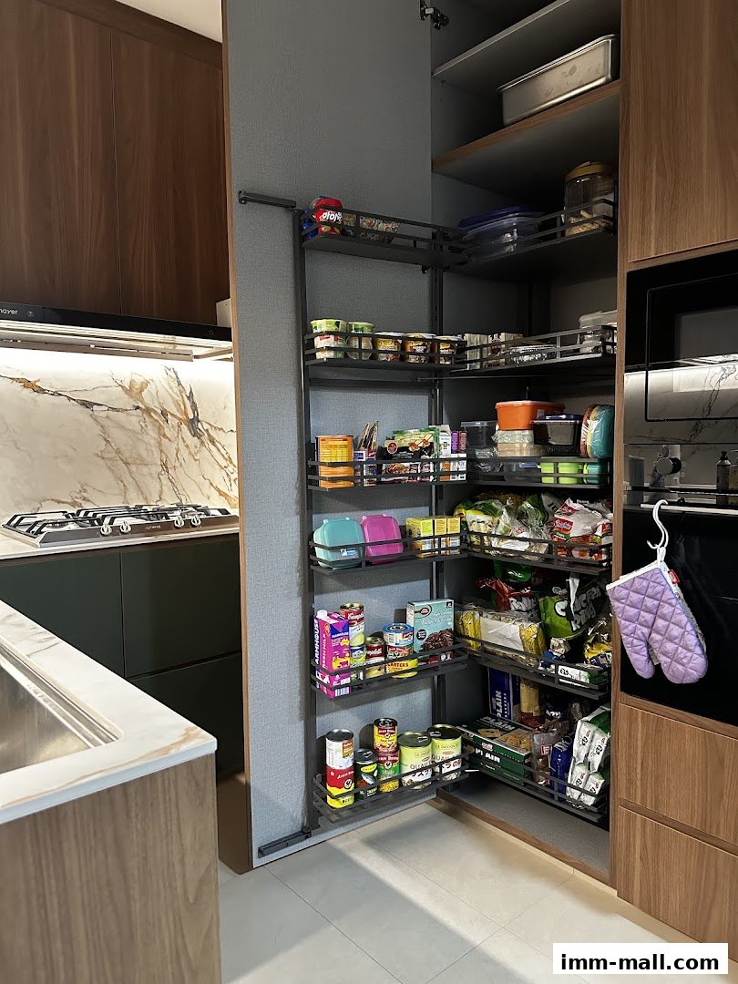 A well-organized pantry with pull-out shelves filled with various food items and kitchenware.