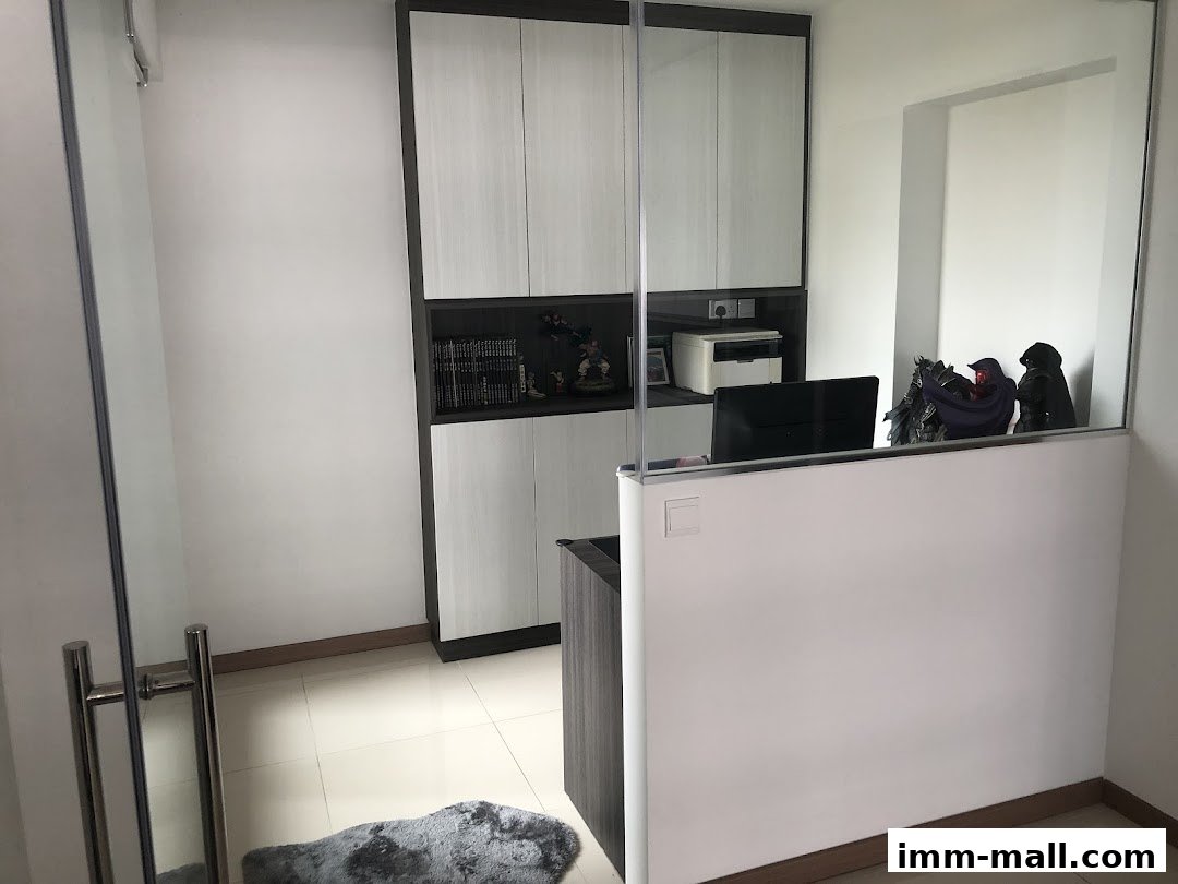 Interior view of GPlan Design Pte Ltd office with modern cabinets and decorative figures.