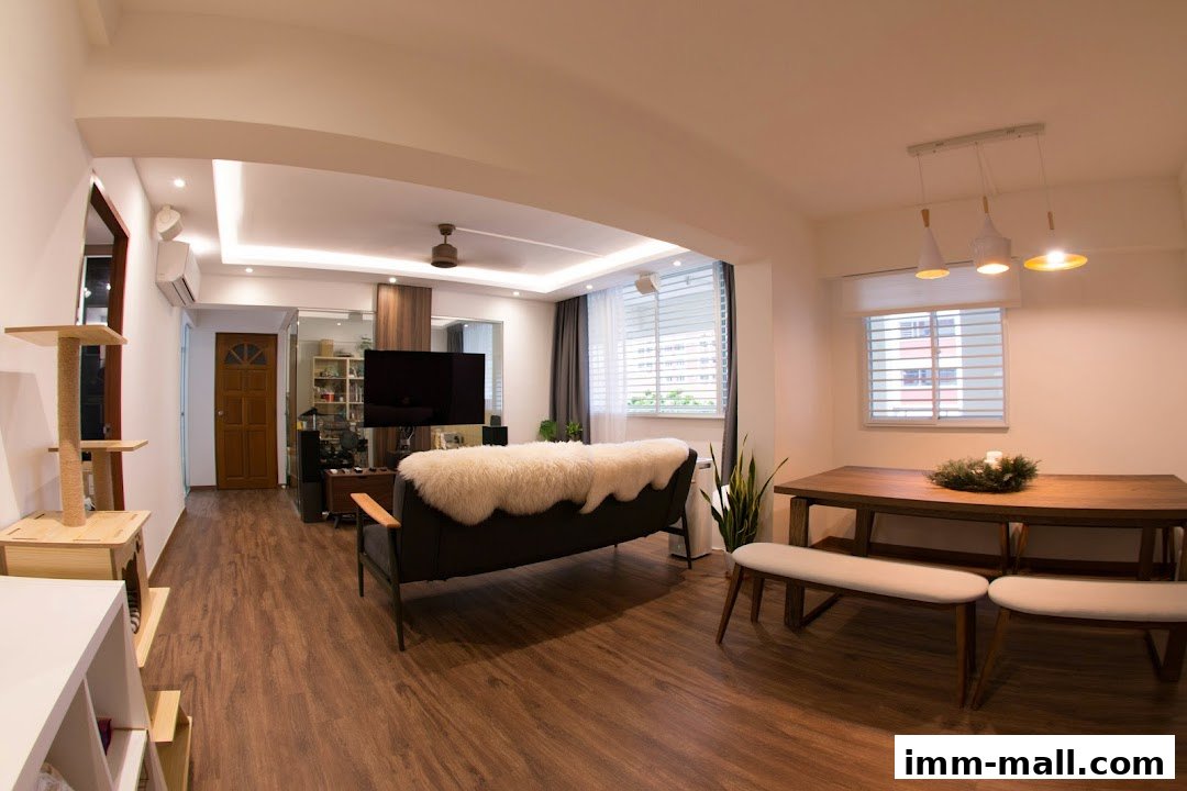 A modern living and dining area with a sofa, TV, dining table, and cat tree.
