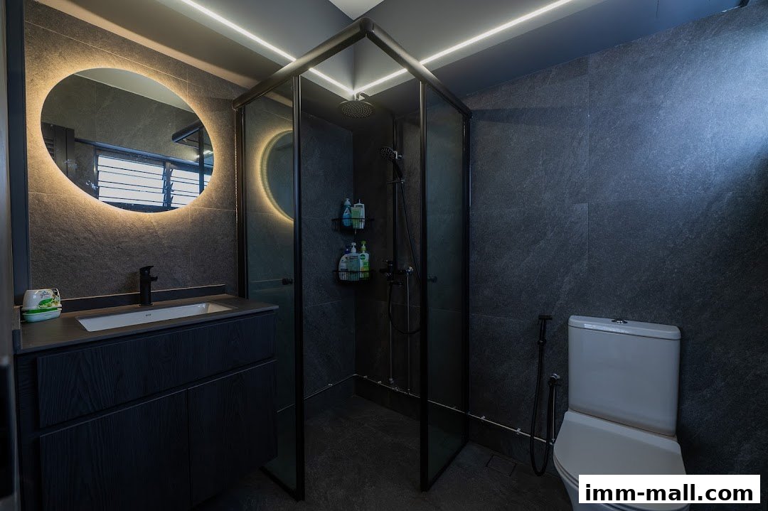 A modern bathroom featuring a dark stone tile design, a sleek vanity, and a glass-enclosed shower.