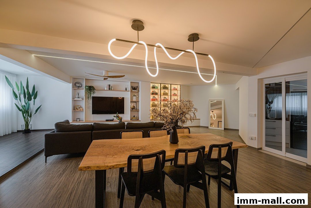 A modern living and dining area with a large sectional sofa, TV, and a wooden dining table.