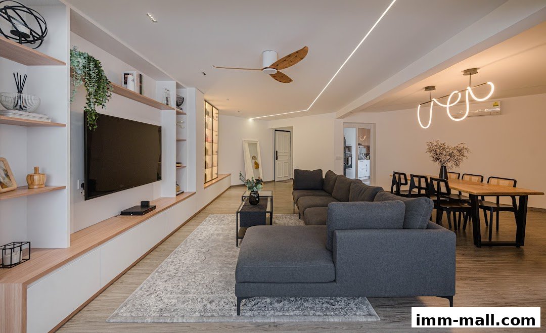 A modern living and dining area with a sectional sofa, TV unit, and dining table.