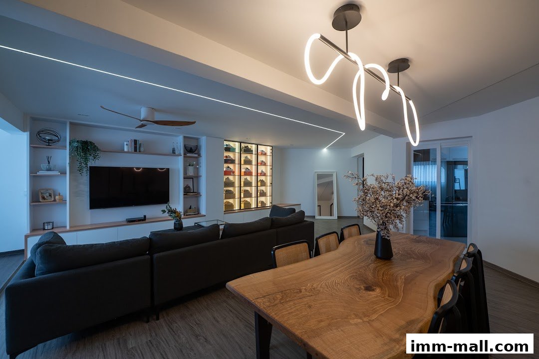 A modern living room with a large sectional sofa, entertainment unit, and a live-edge dining table.