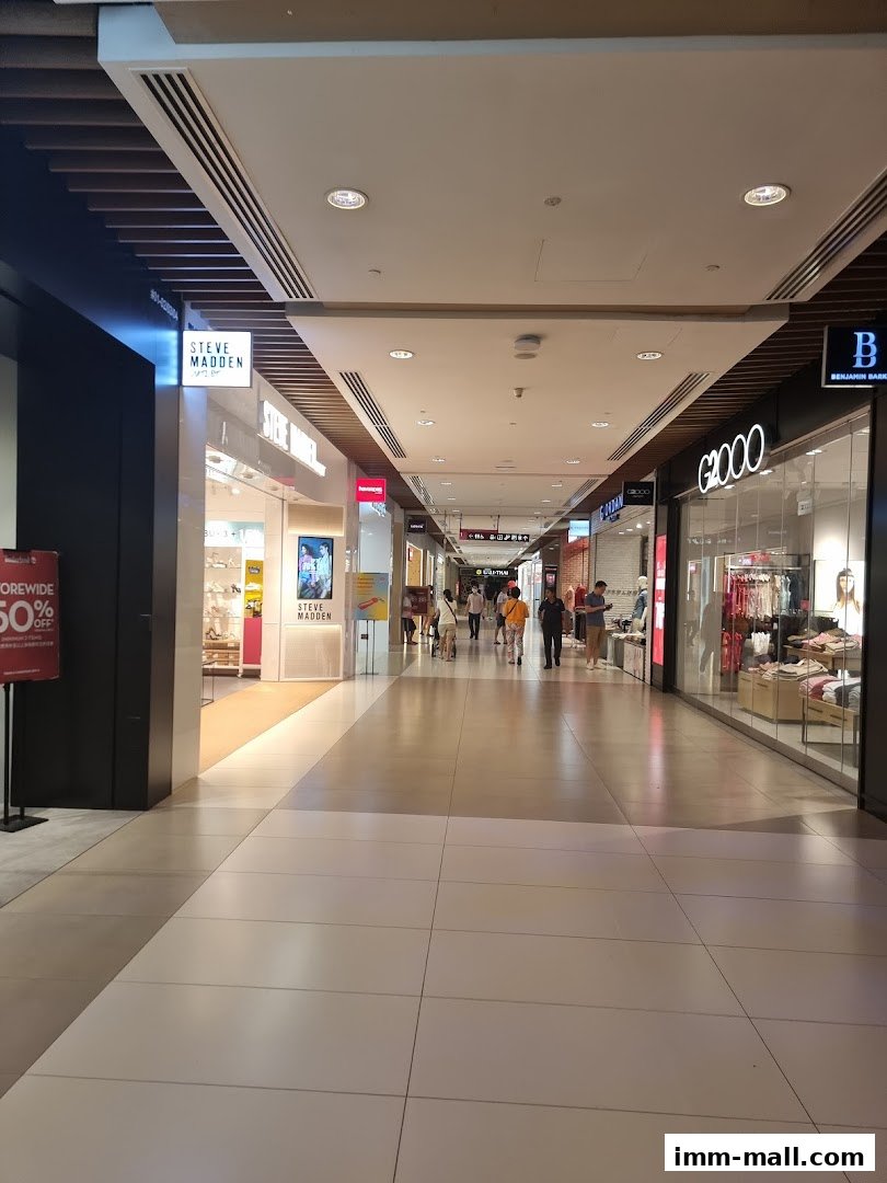 A view down a shopping mall corridor with various stores visible, including G2000.