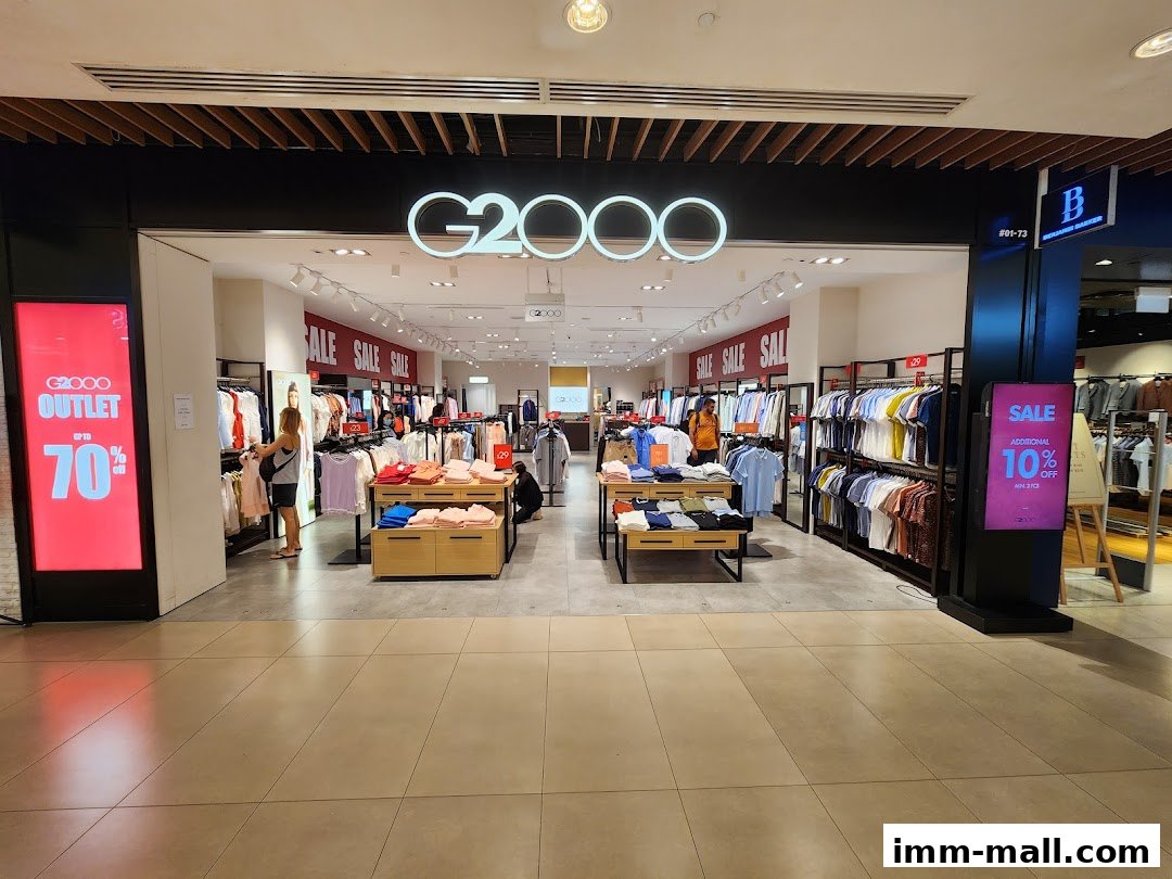 The G2000 store entrance with clothing displays and sale signs.