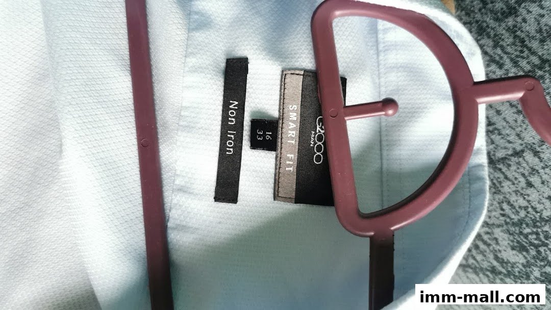 Close-up of a light blue G2000 "Smart Fit" non-iron shirt on a hanger.