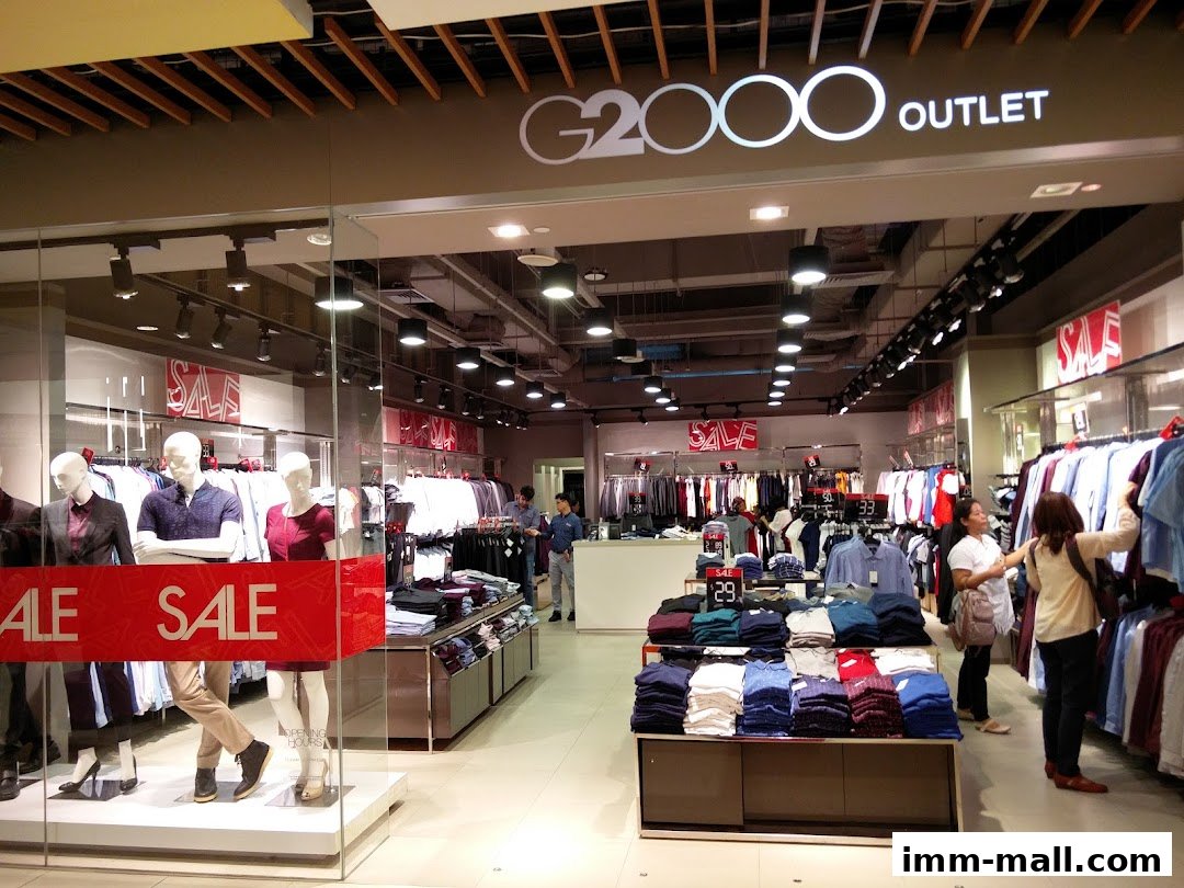 G2000 Outlet store interior with mannequins and clothing displays, featuring a sale.