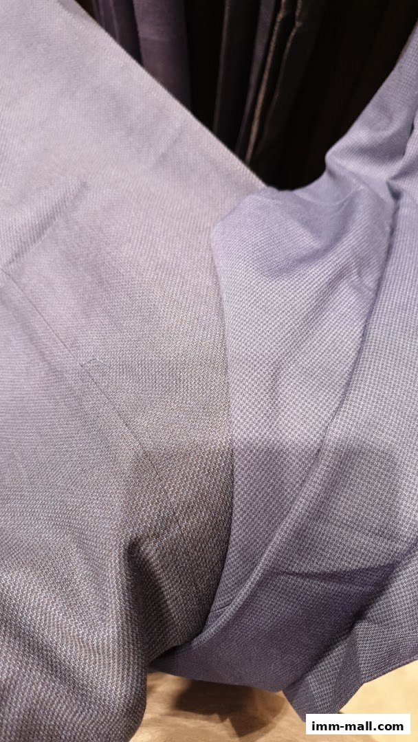 Close-up view of textured blue fabric, likely from a garment.