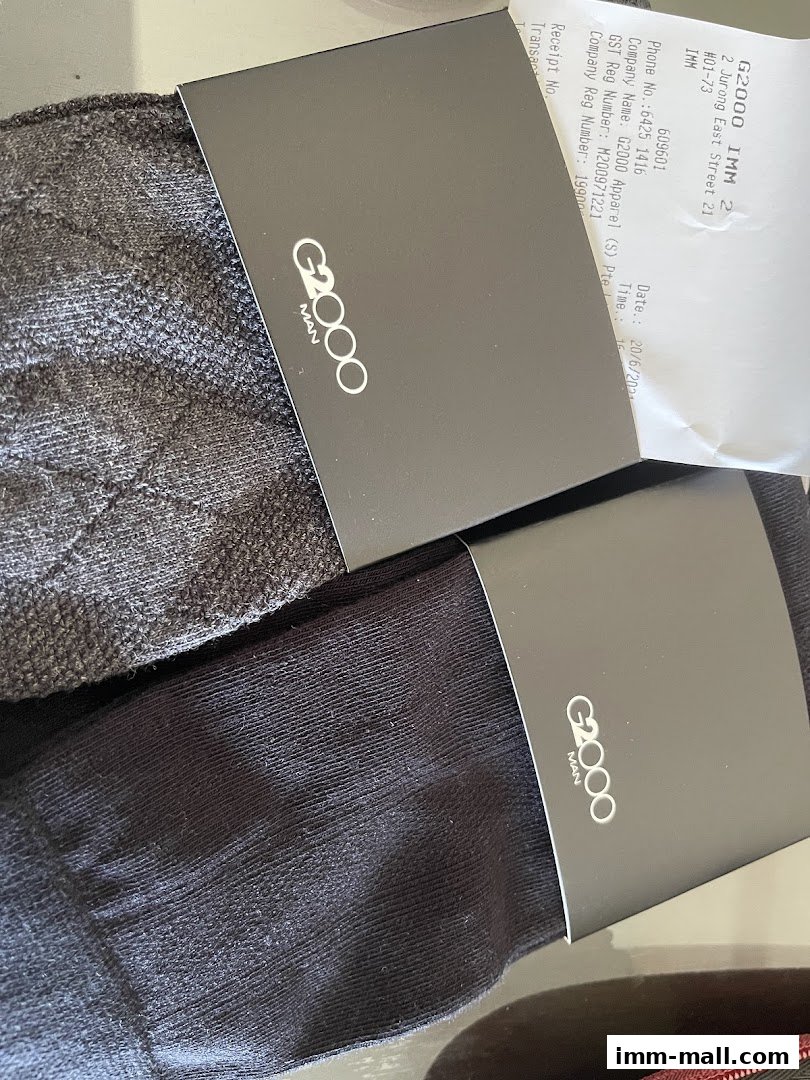 Two pairs of G2000 men's socks with branded packaging and a receipt.