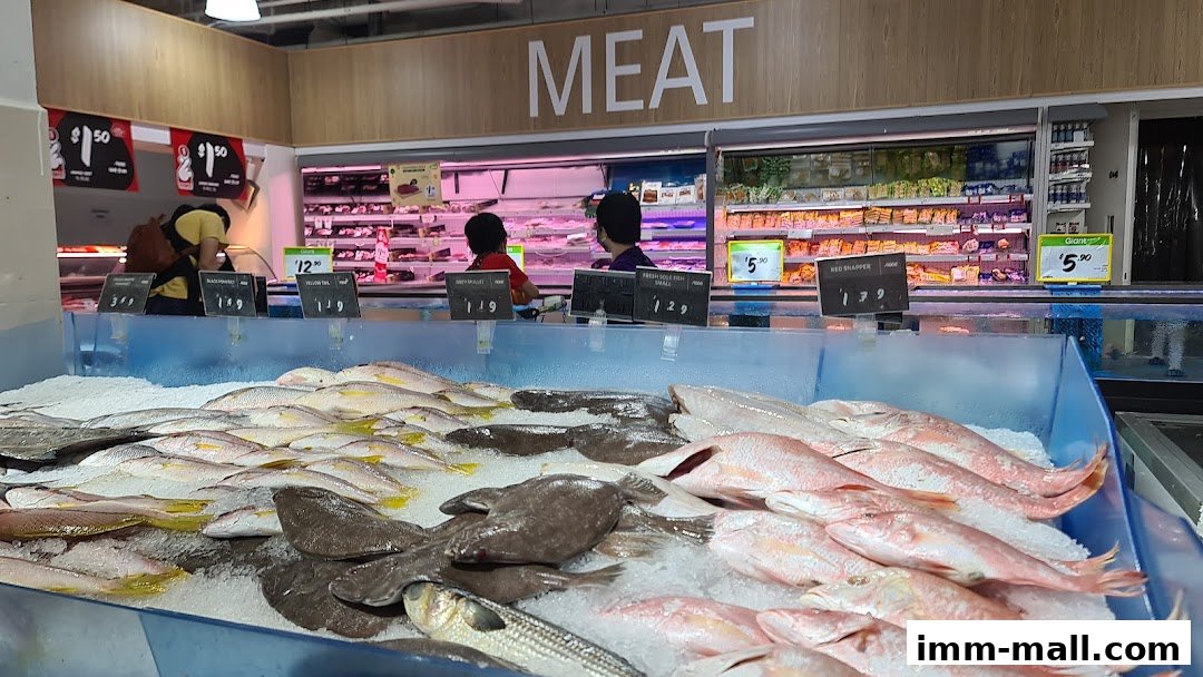 Fresh fish displayed on ice at a supermarket's seafood counter.