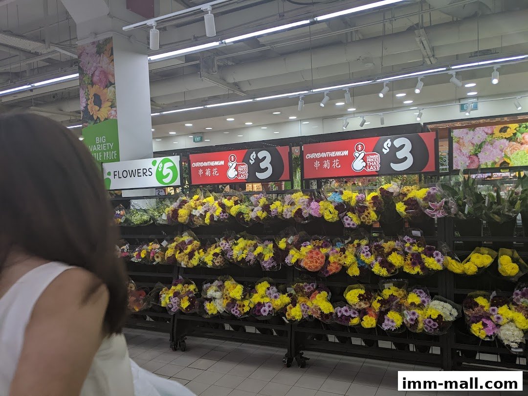 A display of colorful flowers for sale at Giant Supermarket, with prices advertised.