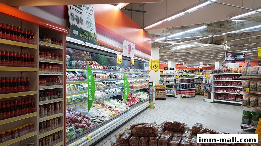 Interior view of a supermarket with aisles of fresh produce and packaged goods.