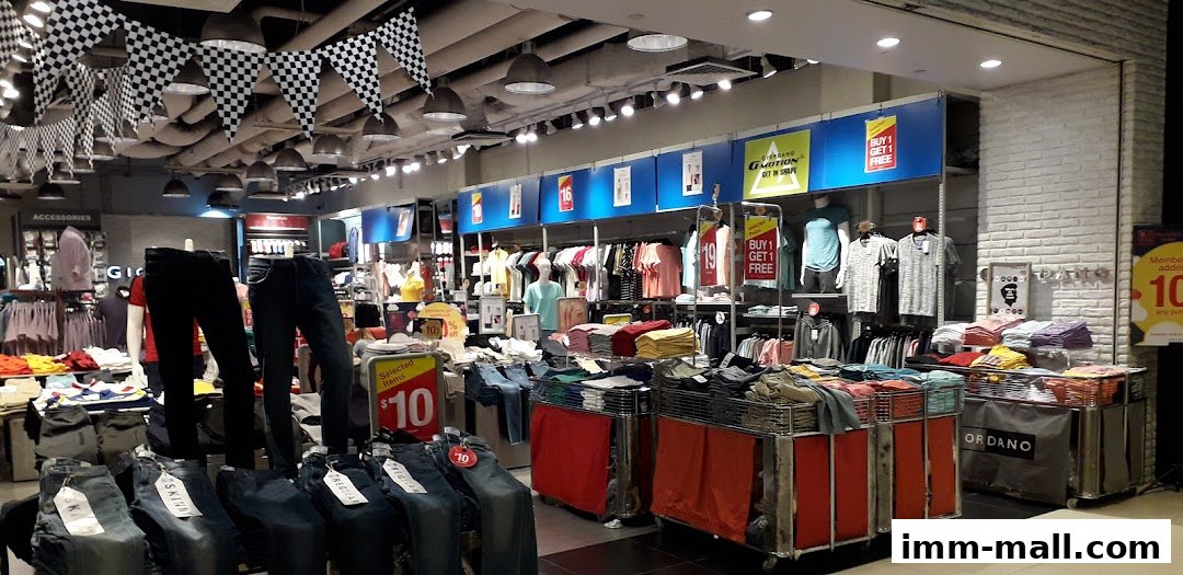 Interior view of a Giordano Outlet store showcasing various clothing items and promotions.