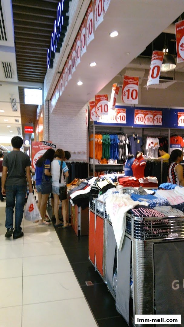 Customers browse clothing displays at Giordano Outlet, with prominent '$10' sale signs.