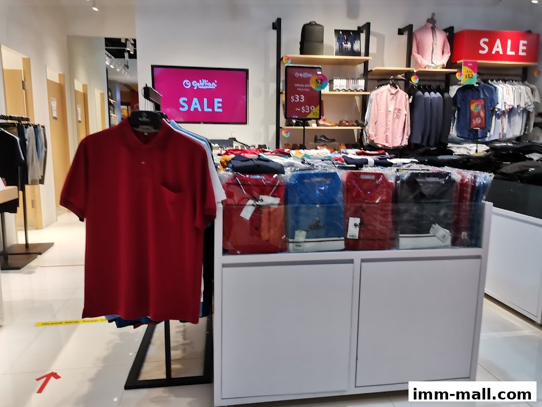 A retail store interior showcasing a sale on men's polo shirts and other apparel.