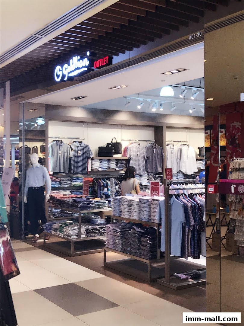 A Goldlion Outlet store displaying neatly folded shirts and hanging apparel.