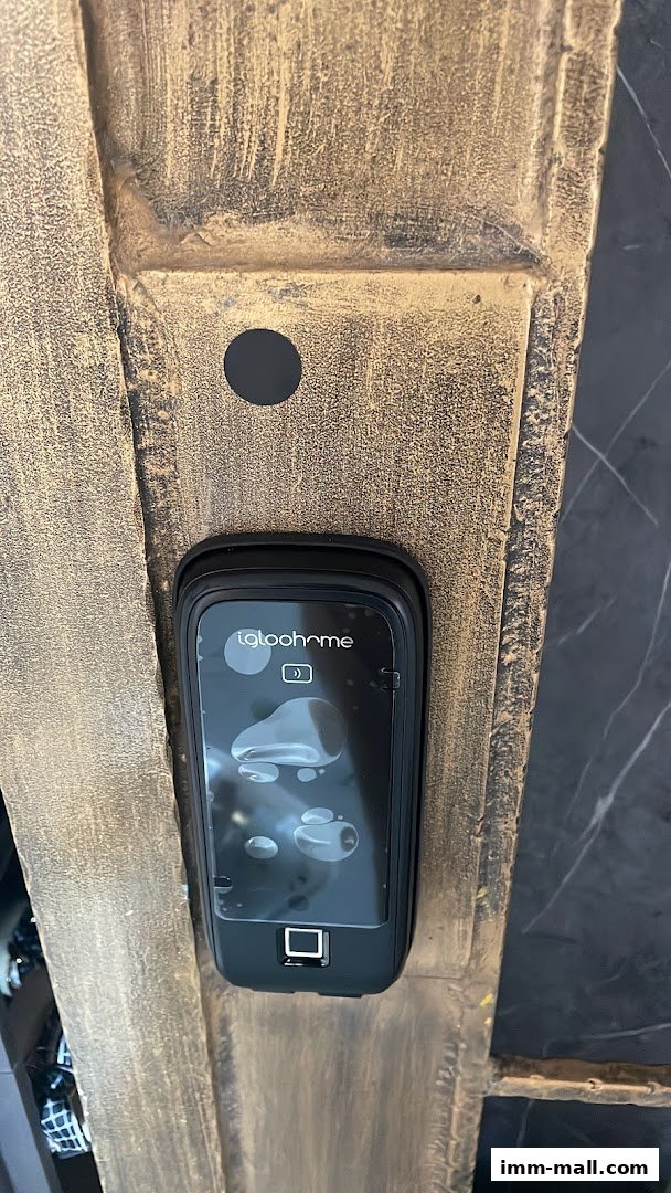 A close-up of a digital lock with a fingerprint scanner and the Igloohome logo.