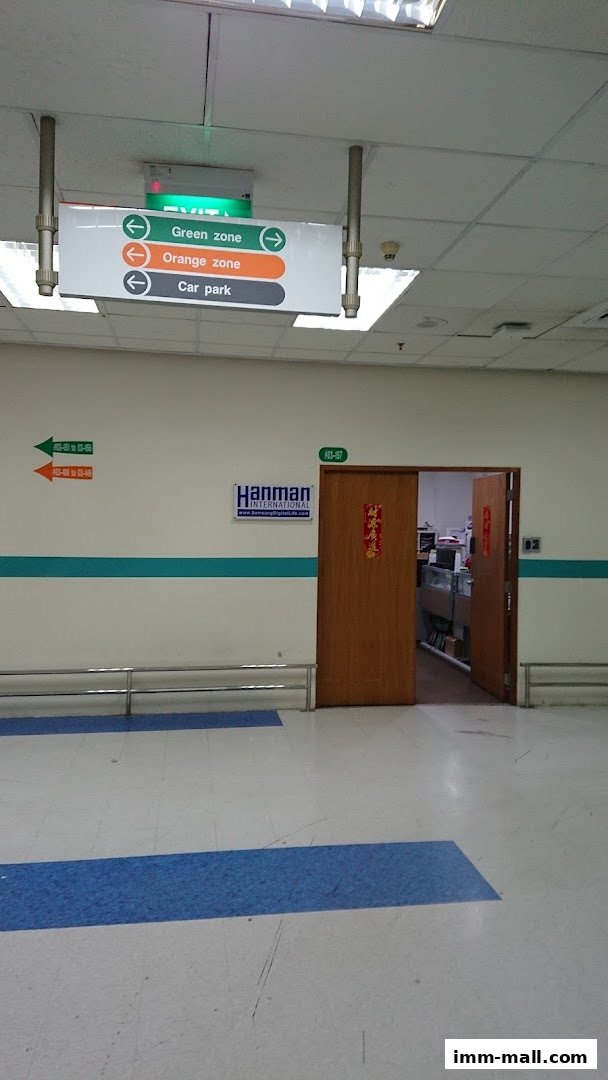 Entrance to Hanman International Pte. Ltd. with directional signs and office interior visible.