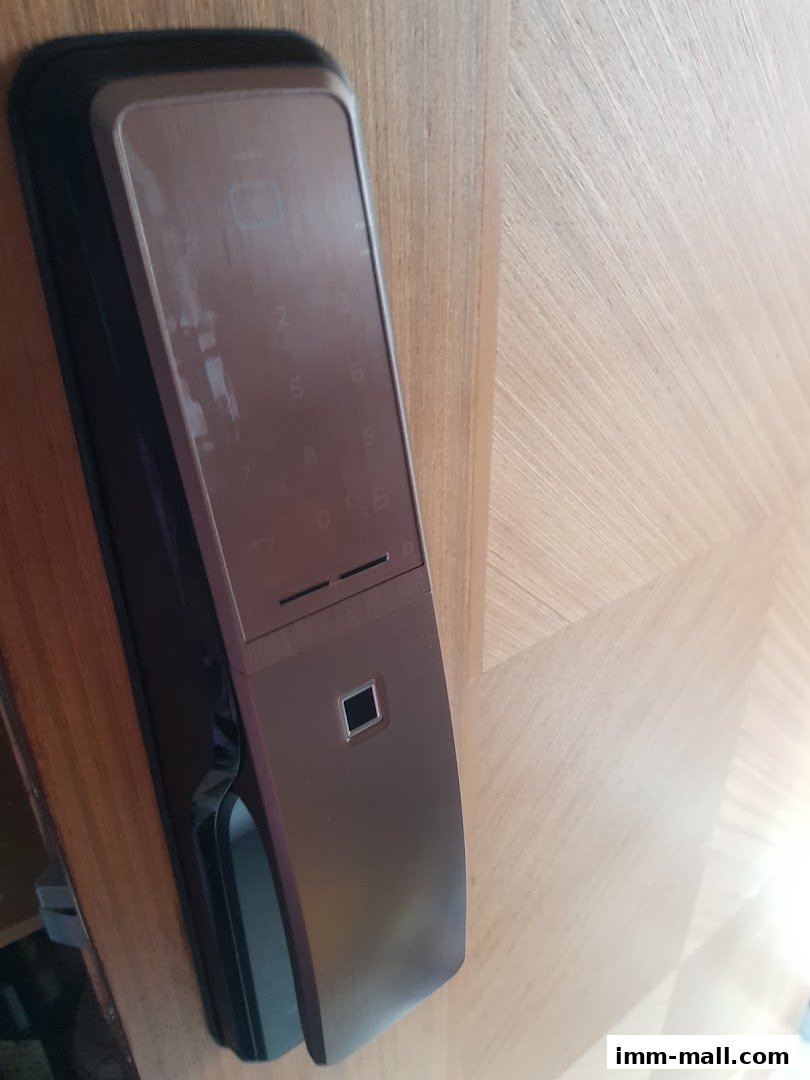 A close-up shot of a modern digital door lock with a keypad and fingerprint scanner.