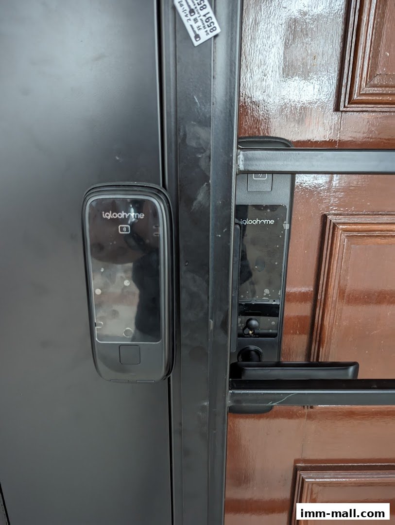 Close-up of a modern digital door lock system on a wooden door.