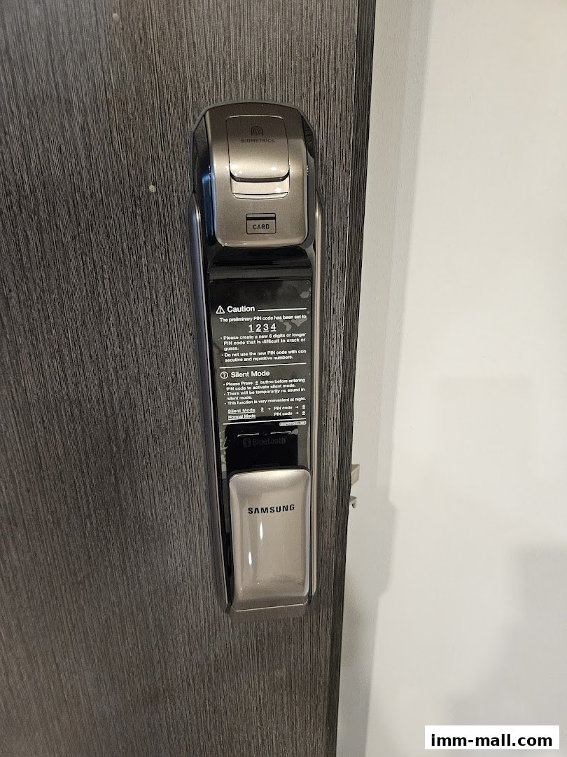 A close-up of a modern Samsung digital door lock with biometric and card access.
