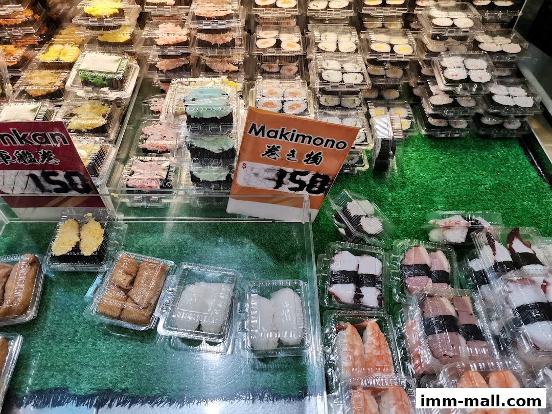 A display of various pre-packaged sushi rolls and nigiri in clear plastic containers.