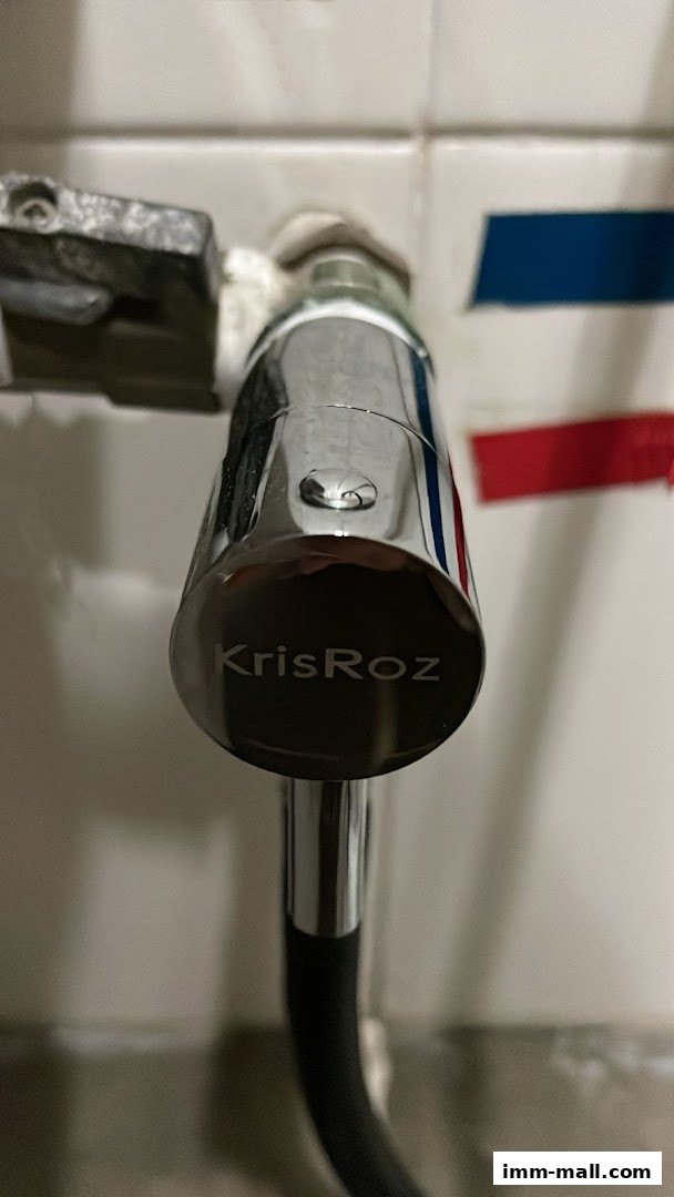 Close-up of a chrome faucet with the brand name 'KrisRoz' engraved on it.