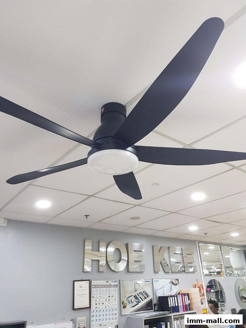 A modern black ceiling fan with five blades is displayed in a showroom.