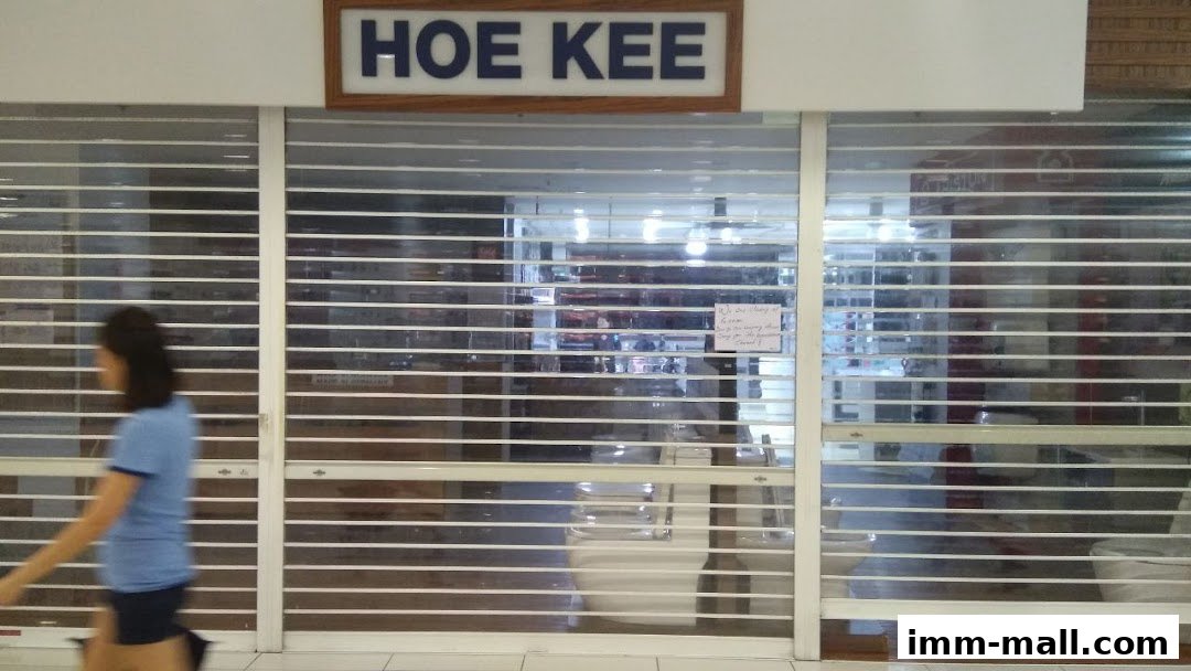 The closed storefront of Hoe Kee Hardware Pte Ltd IMM Showroom with roller shutters down.