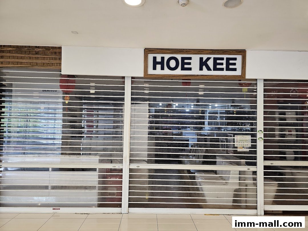 The closed storefront of Hoe Kee Hardware Pte Ltd IMM Showroom with rolling shutters down.