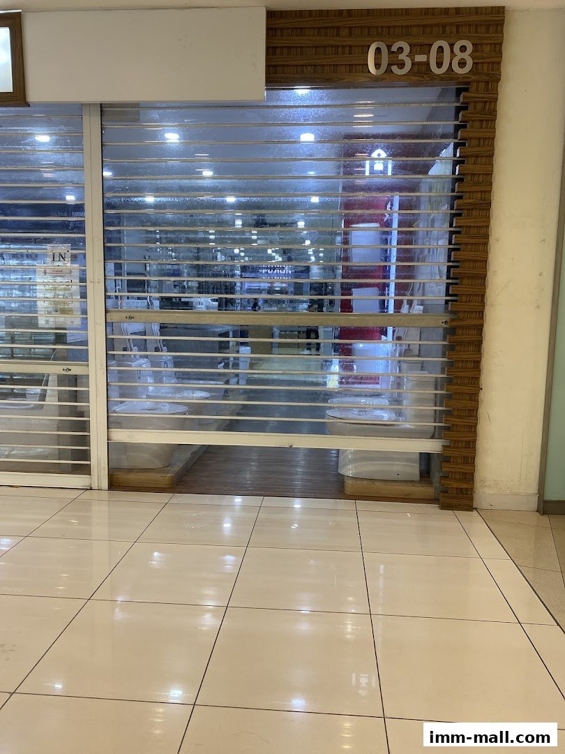 The closed storefront of Hoe Kee Hardware Pte Ltd IMM Showroom with roller shutters down.