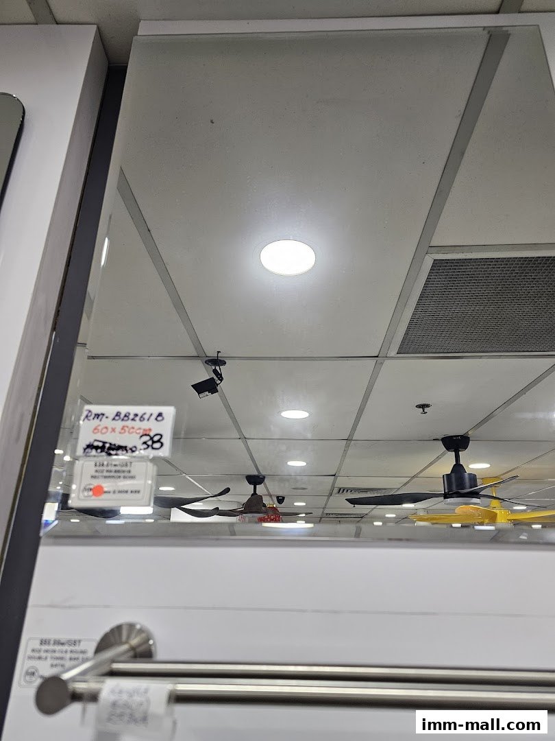 Reflection of ceiling fans and a product label in a mirror at a hardware store.
