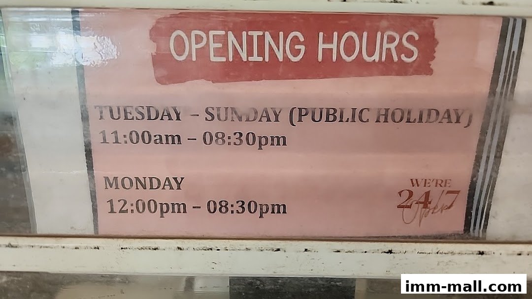 A sign displaying the opening hours for a shop, including weekday and weekend hours.